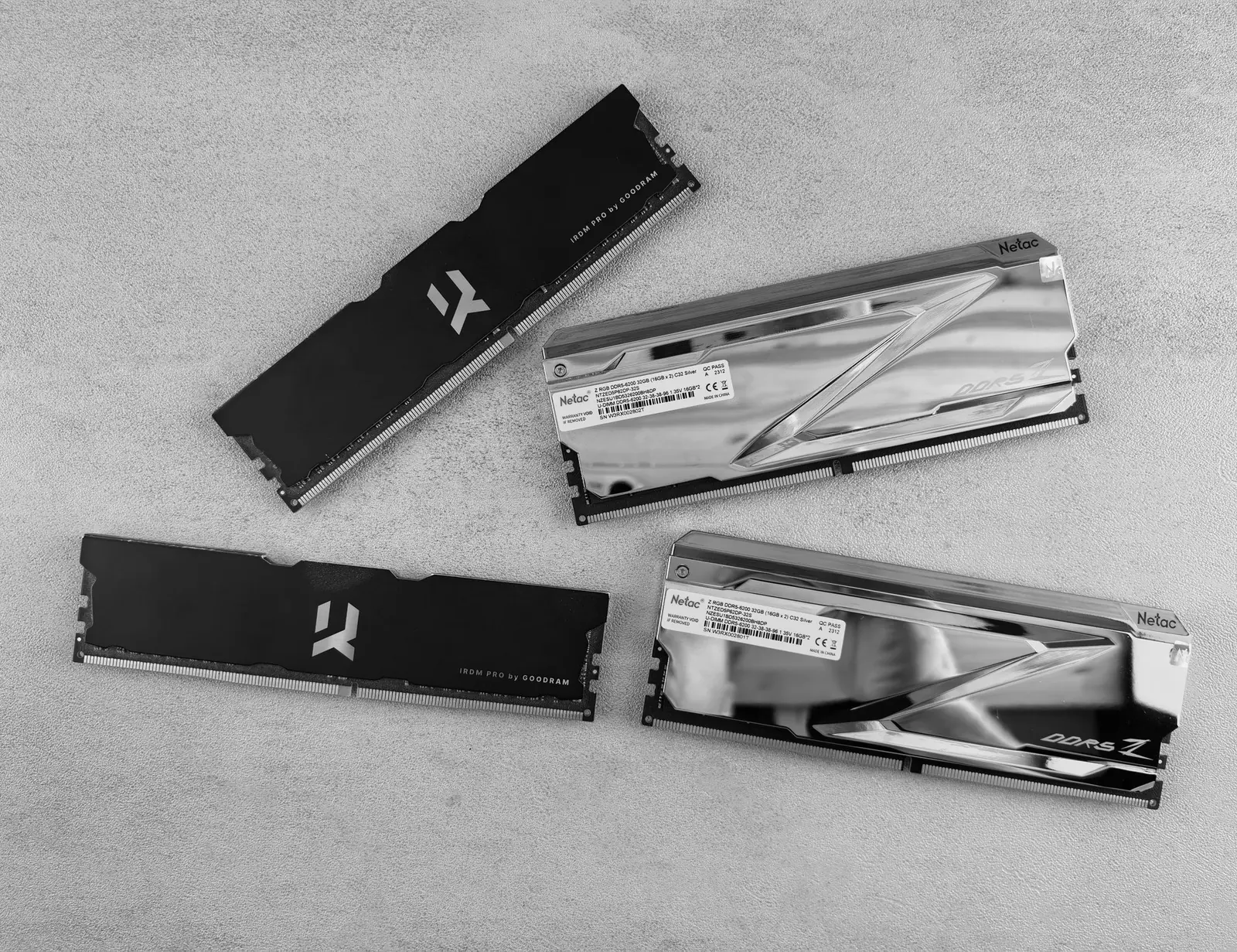 Four computer memory modules arranged on a pale textured surface.