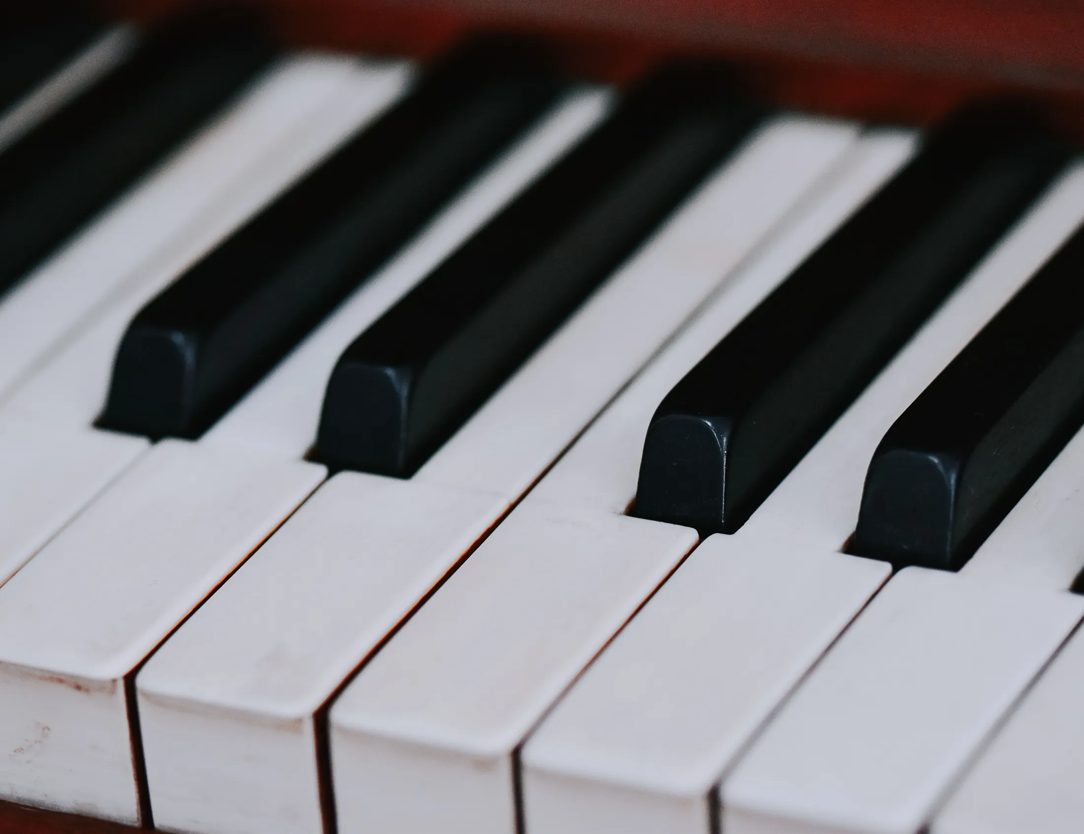 A close monochrome view of piano keys arranged in a repeating pattern of discrete levels.